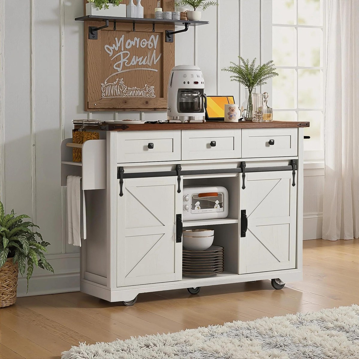 Image 7: Static image from an Amazon-referencing kitchen-furniture record showing a white cabinet with sliding barn-style doors, upper drawers, wheels, plates, and a coffee setup